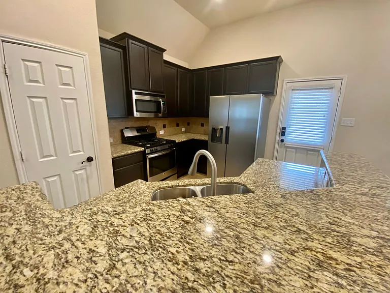 Granite counters, stainless steel appliances, plenty of cabinet and pantry space