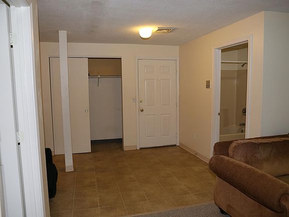 Living room looking toward door & bathroom