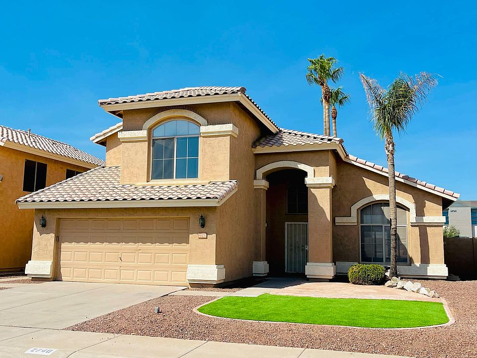 Front yard, low-maintenance with artificial turf and large flagstone area.