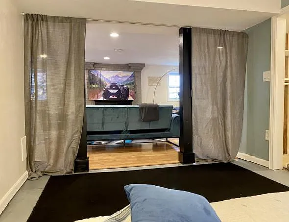 View from within bedroom alcove out to rest of lower level. A closet is just out of view on the right.