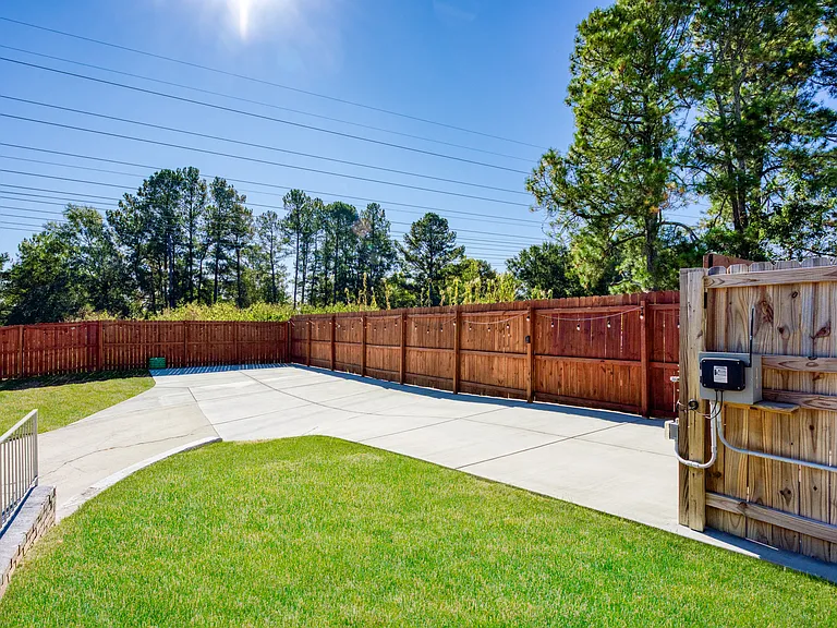 Beautiful backyard with fenced, secure parking for two cars.