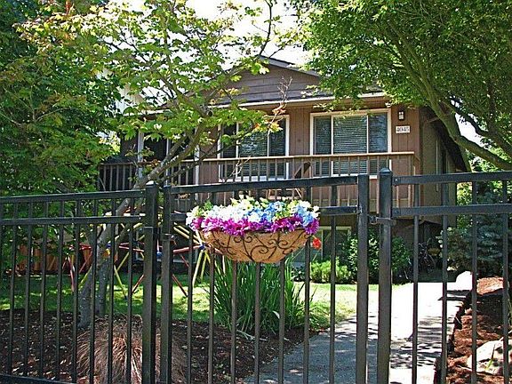 Welcome to 4045 46th Ave. SW. Set back from the street, gated and fenced, this property offers elega