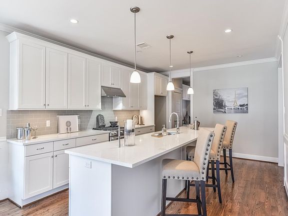 Impressive kitchen has breakfast bar, gas range and bright finishes.