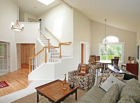 Vaulted foyer, spindle staircase, living and dining areas
