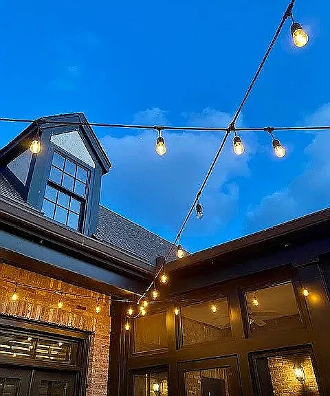 cafe lights above courtyard provide perfect ambiance both outside and view from inside.