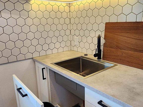 Lazy susan above and convenient slide out trash compartment.