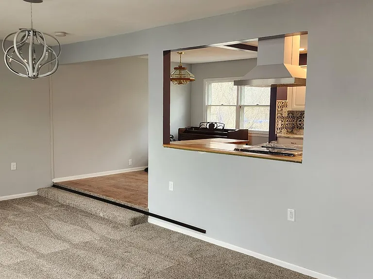 View of the living room, dining room, and the kitchen. New carpet, new paint, new vinyl flooring, new light fixtures, new appliances, etc