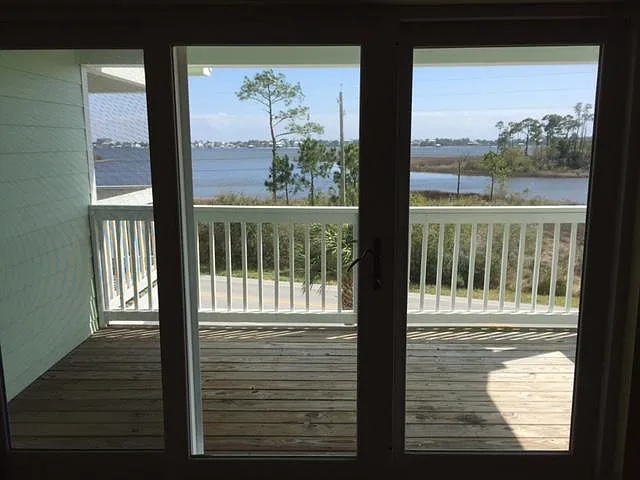 The upstairs master deck offers serene relaxation- perfect for morning coffee and distant bird calls over the tranquil ICW.