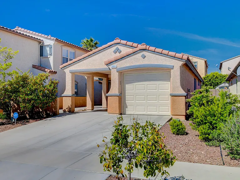 Front Exterior (enclosed garage for one car and covered carport for another)
