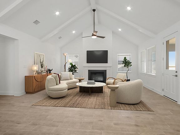 Great room with vaulted ceiling and fireplace