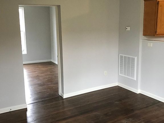 Bedroom off the living room, with refinished hardwood flooring.