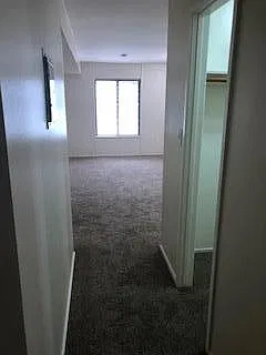 from bathroom hallway looking into bedroom