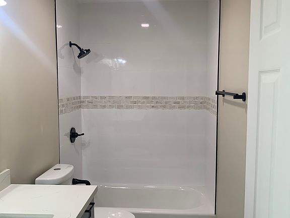 New renovated bathroom. New flooring, vanity, countertop, toilet, tub and tiling. Finishes in oil-rubbed bronze.