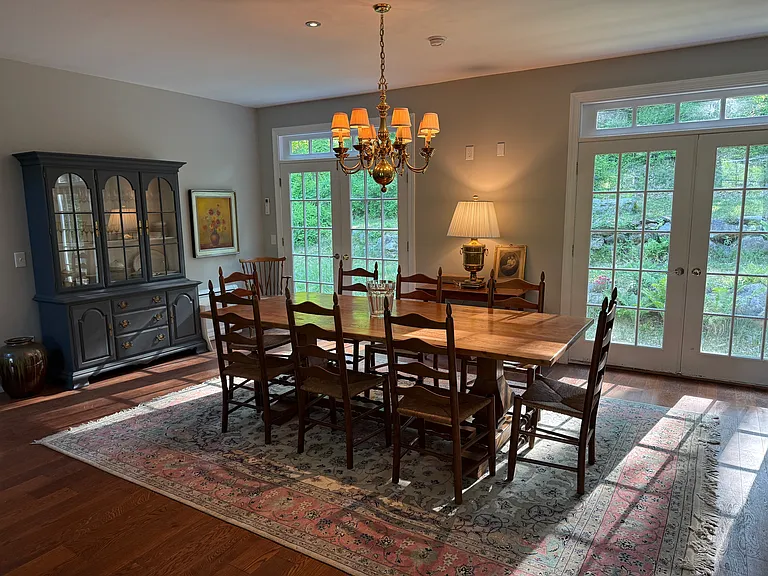 Dining room has an eight-foot table, and is set for eight. But there are more chairs for larger gatherings