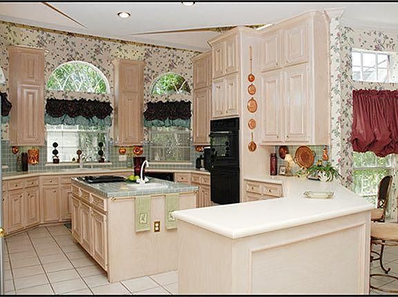  GOURMET ISLAND KITCHEN with architectural flair! Glazed oak 66'' cabinets w/extra cabinets above,corian & tile countertops, DBL convection ovens, lg walk-in pantry, Jennaire cooktop w/indoor grill & added griddle & Italian tile floors.