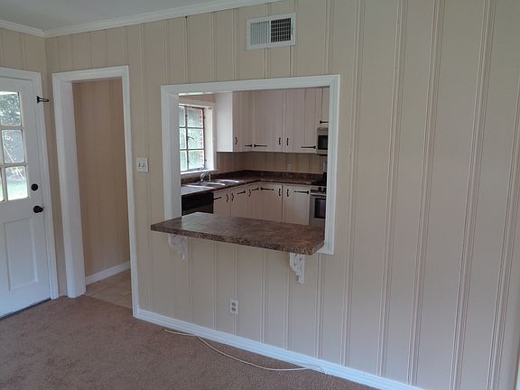 Den opens into kitchen