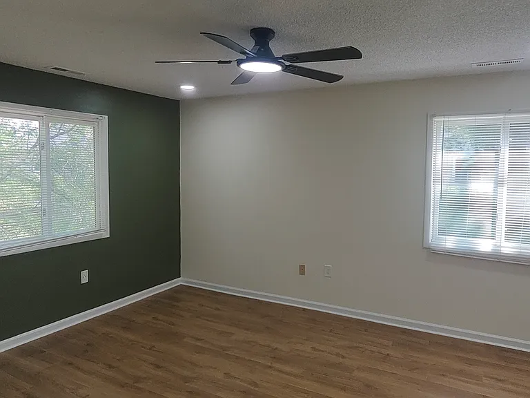 Master bedroom with two windows.