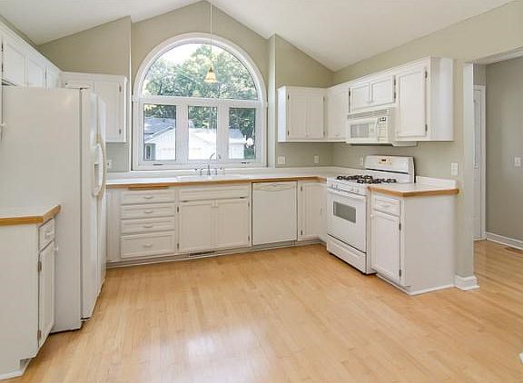 The kitchen is very open and bright, with a large half moon window letting in tons of natural light!