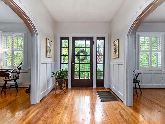 The home is graced with arches connecting living spaces. Lots of light and wonderful hardwood floors throughout.
