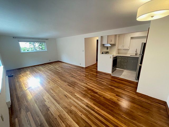 This is the view when you open the front door to 2515 Minor Ave E. You see the living room/dining area and kitchen, plus hallway to bedroom and bath.