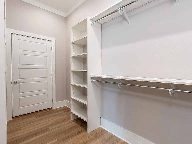 Walk-in closet with solid shelving