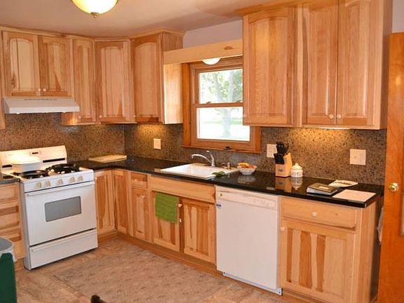 Just last year the kitchen was totally remodeled.  It now contains Hickory cabinets, granite counter tops and a back splash.  The appliances are white and will be staying with the home. 