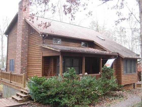 Covered front porch wraps all the way around to open deck