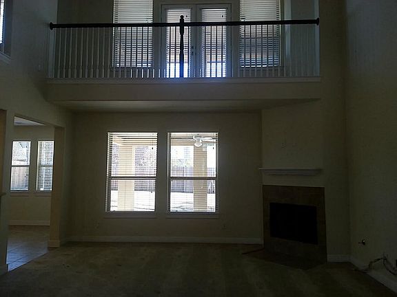 Beautiful View of the 2 Story Family Room From the Front Entry Way with a Catwalk to the Balcony