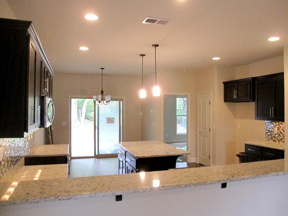 Stunning Kitchen with granite, hardwood, S/S appliances, large island & raised bar.