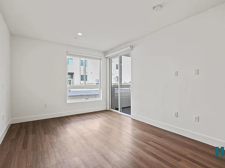 Living Room with Vinyl Flooring, Recessed Lighting, Large-Size Windows,and Patio