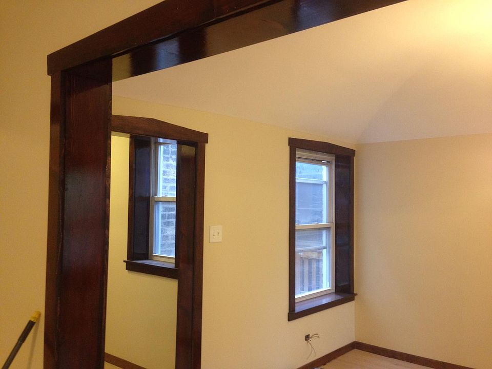 Living room windows just after we re-wired the apartment. Hand stained window framing.