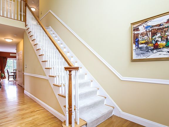 2 Story entry hall with hardwood floors throughout first level