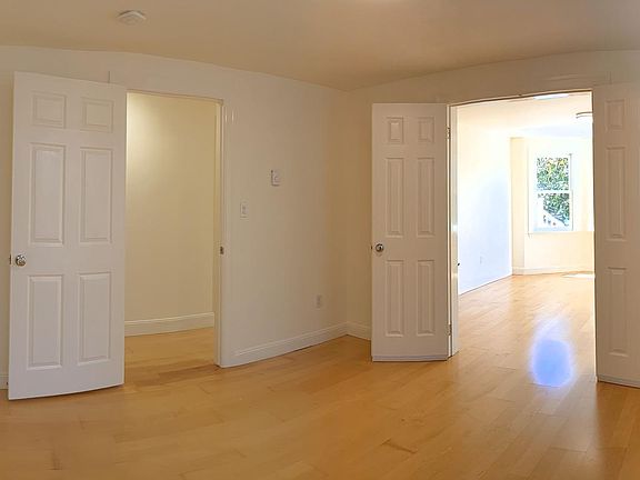From the dining room / front bedroom looking into the hallway and living room