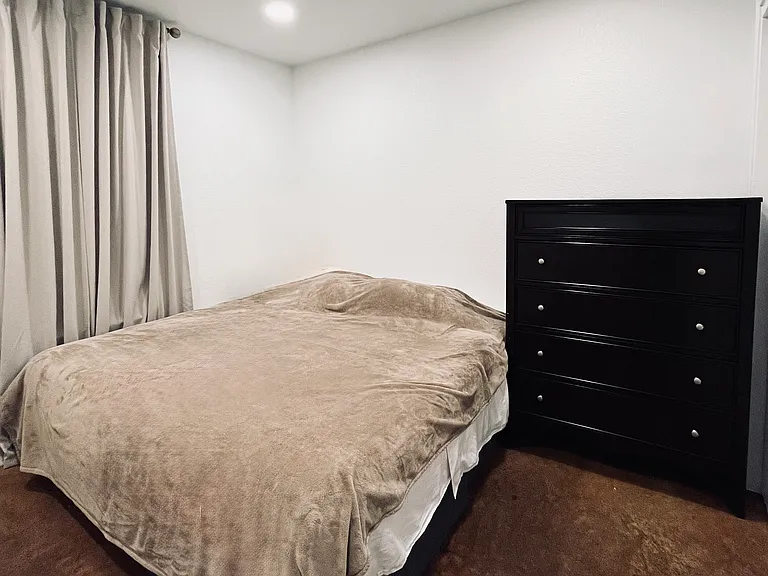 A spacious bedroom offers plenty of room for visitors or can be used as a home office or hobby space. Has closet.