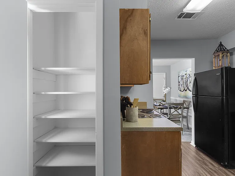 houghtfully designed kitchens with black appliances and classic wooden cabinetry at Lakeland East Apartments in Flowood, MS. Managed by Highlands Vista Group.