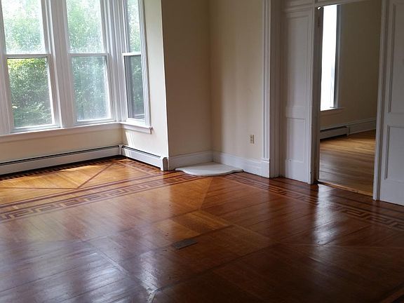 living room with large windows and inlaid floors
