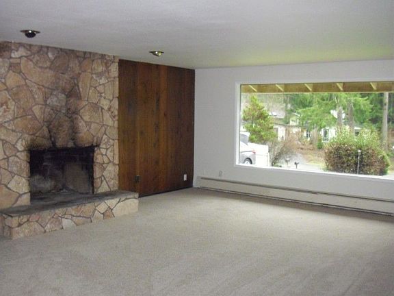 Large, Well-Lit Living Room with Built-In Fireplace