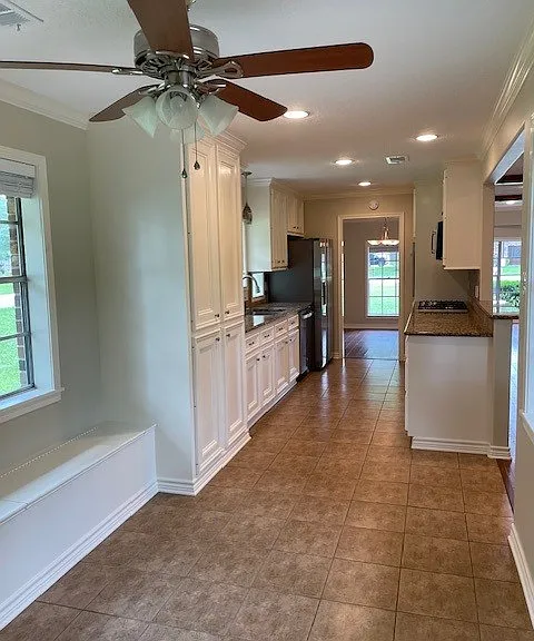 Alternative dining area with built in bench, opens for extra storage. This area has windows on both sides.