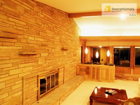 Impressive wall of limestone showcases living room fireplace and