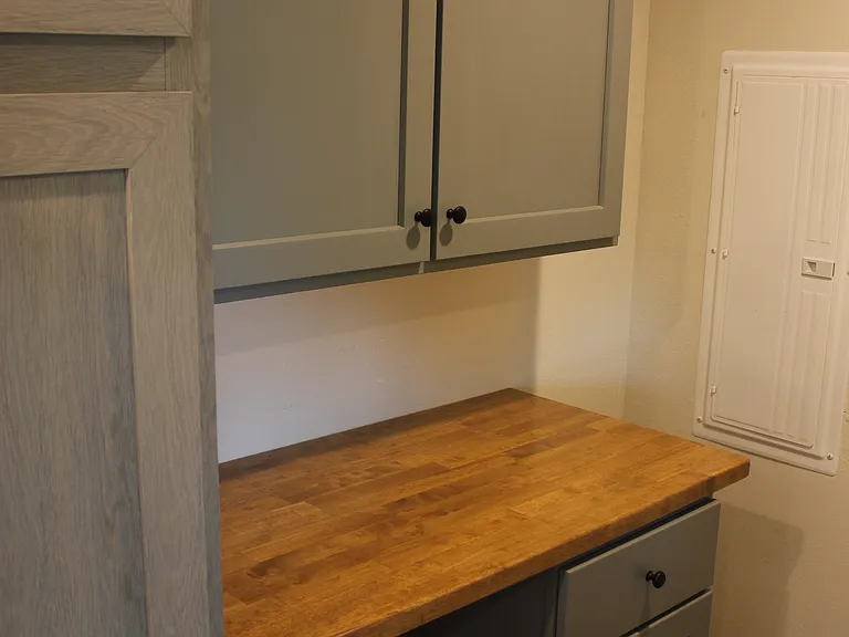 Utility room with butcherblock top and cabinets