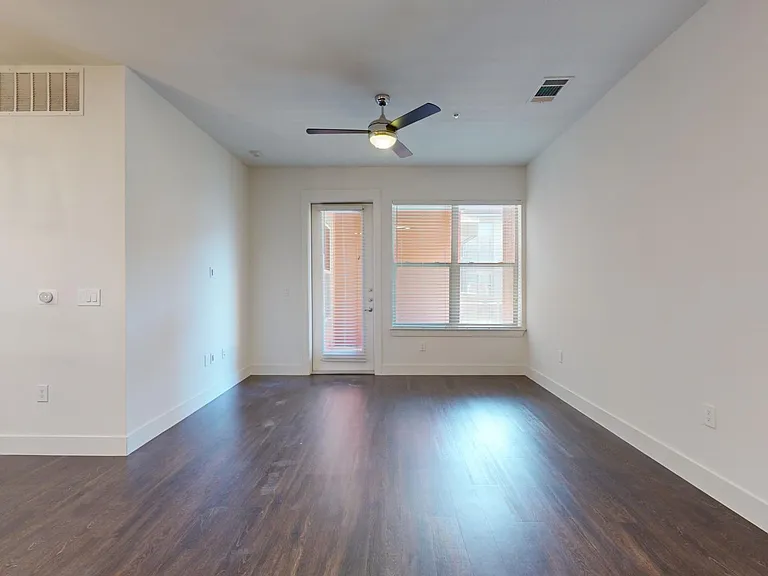 Apartment living room with wood-style flooring.