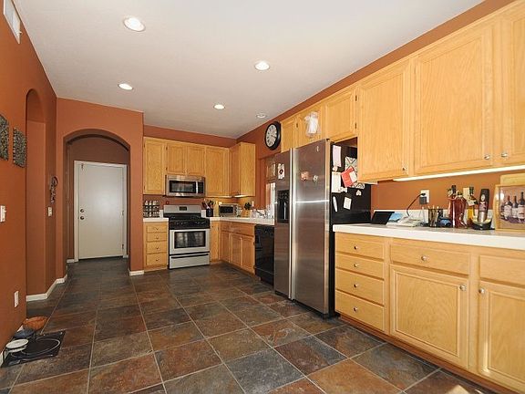 Large Gourmet Kitchen with lots of cabinets and slate flooring.