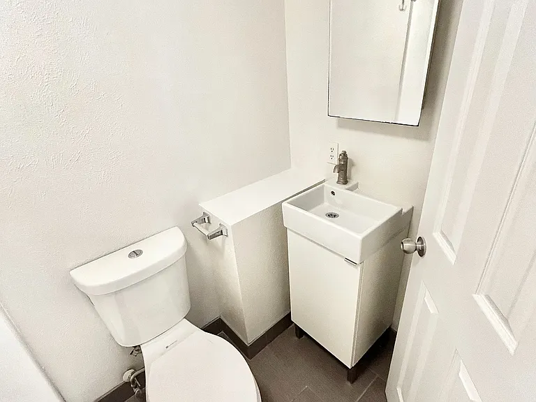 Contemporary bathroom with sleek fixtures, elegant sink, and modern tile flooring in a minimalistic design.
