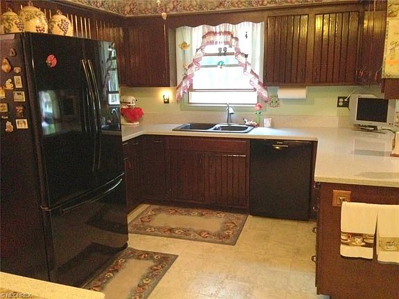 Eat-in kitchen featuring Corian countertops, built-in appliances and a breakfast nook (not shown in this photo)