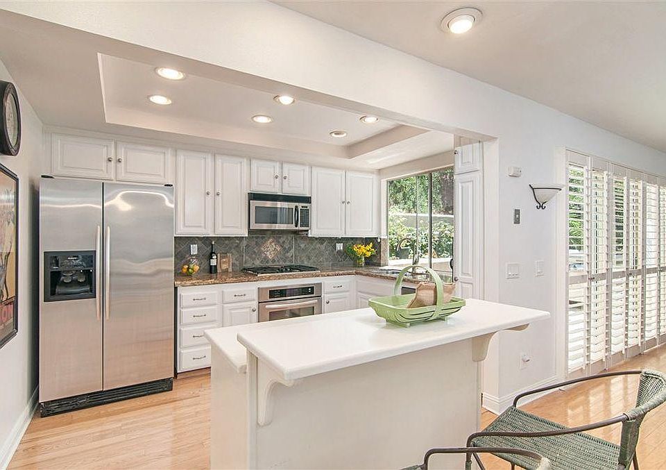 The kitchen has a new refrigerator and dishwasher. This is old photo