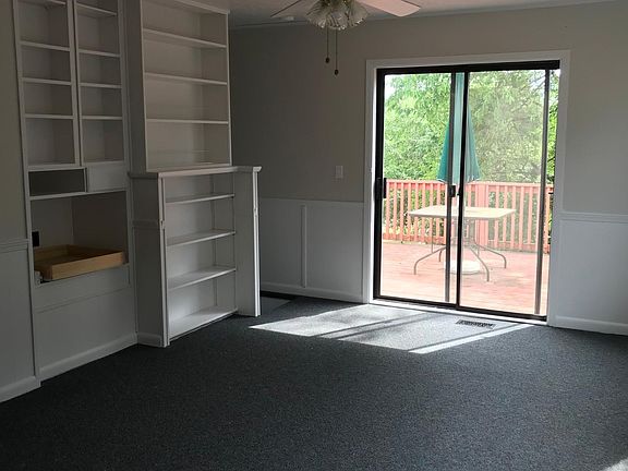 Family room looking out to deck and showing beautiful built 