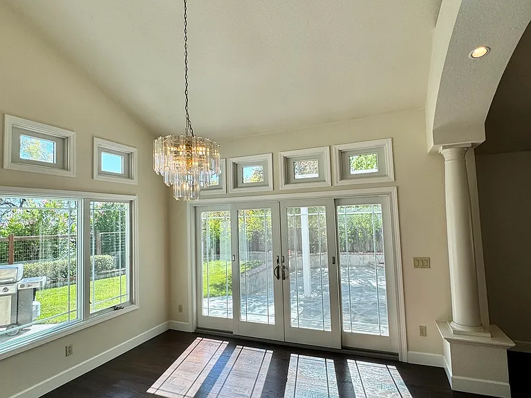 Dining room with large windows and sliding doors providing direct access to the patio