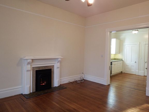 Living room into kitchen. Original pocket doors can close off the kitchen.