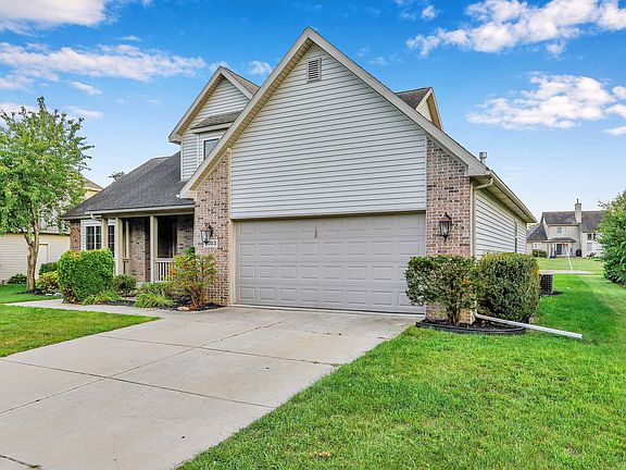 two-car front-facing garage with night lamps, on a remote control access with garage door opener.