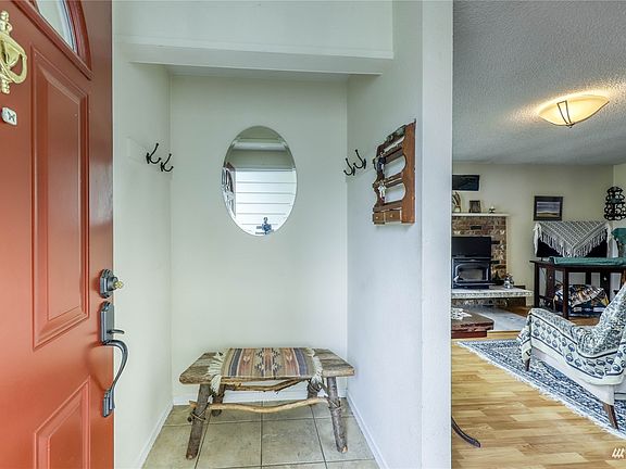 The covered entry leads into the tiled foyer.>